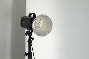 Closeup flash light stand: photo studio interior