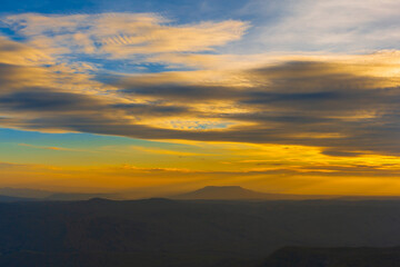 The sun falls on the red circle and the mountain view