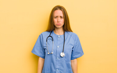 pretty blonde woman feeling sad and whiney with an unhappy look and crying. nurse concept