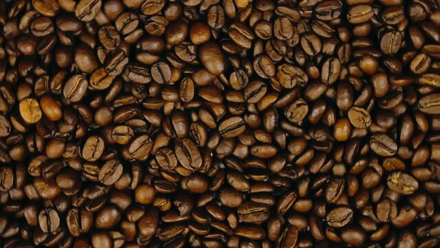 The coffee beans on the turntable. The coffee beans spin rotate. Twist, create pattern, make design picture.