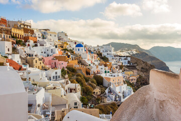 houses on cliff of Oia town at sunset in Santorini, Greek islands, Greece