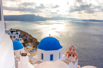 houses on cliff of Oia town at sunset in Santorini, Greek islands, Greece