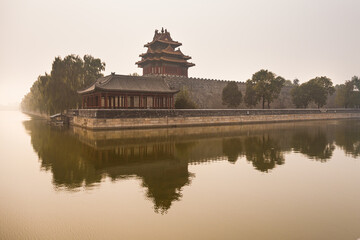 Fototapeta premium Forbidden City Corner Tower at sunset with reflection, Beijing, China