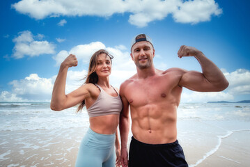 Fototapeta premium Sport man and woman exercise on beach at daytime