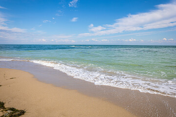 Beautiful bright colorful tropical summer background. Soft turquoise blue ocean wave on golden sandy beach.