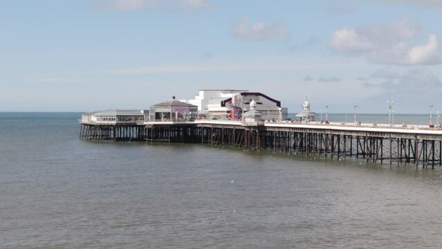 Pier with leisure buildings on and the sea below