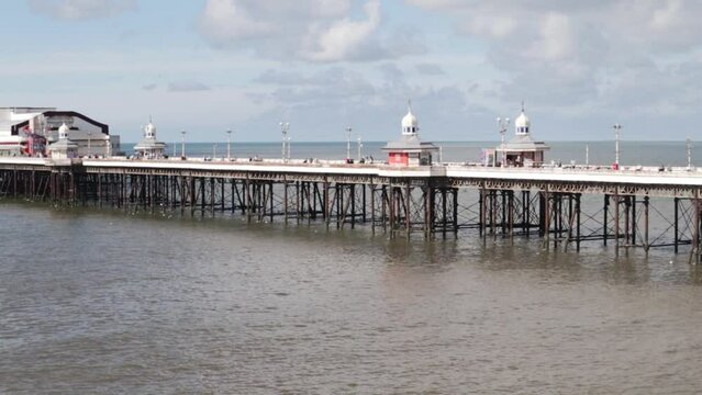 Pier with please leisure buildings on with the sea below