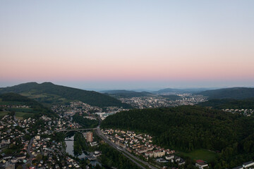 Amazing shot of a beautiful landscape in the alps of Switzerland. Wonderful flight with a drone over an amazing landscape in the canton of Aargau. Epic view at sunset over a village called Nussbaumen.