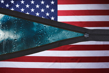 Flag United States America with an unbuttoned zipper and background with rainy weather and clouds behind glass.