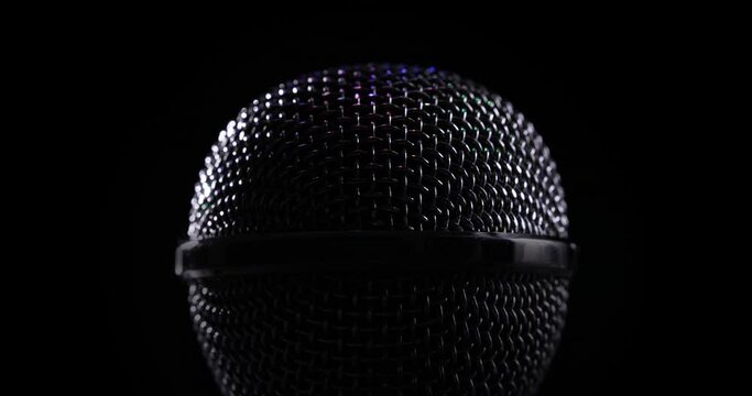 A microphone head is spinning on a black background.