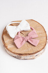 Two elastic bands for hair with a bow on white background. Handmade elastic hair bands