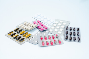 Medical pills and capsules in a blister pack isolated on white background