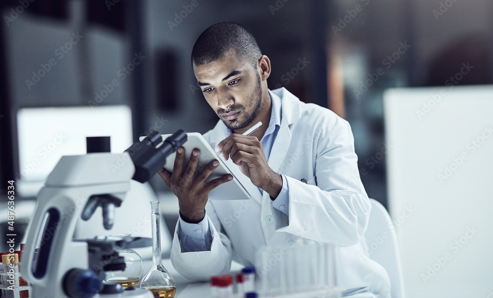 Aufkleber organizing the test results. shot of a scientist recording his findings on a digital tablet.
