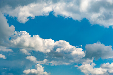 Fototapeta na wymiar Fluffy white clouds and blue sky