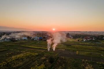 Aerial view of agricultural waste bonfires from dry grass and straw stubble burning with thick smoke polluting air during dry season on farmlands causing global warming and carcinogen fumes