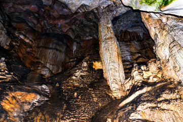 Crimea, Ukraine. Stalactites, stalagmites on the walls of the Emine-Bair-Khosar cave. Template for design. Selective sharpness.
