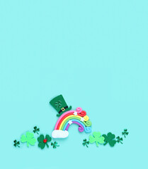 clover leaves, toy rainbow and leprechaun hat on abstract green background. symbol of 17 march, irish traditional holiday St. Patrick’s Day. flat lay. copy space