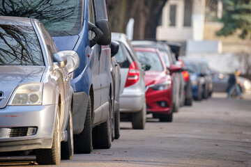 Naklejka premium City traffic with cars parked in line on street side