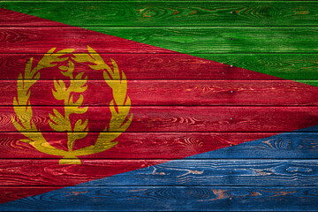 The national flag of Eritrea is painted on a camp of even boards nailed with a nail. The symbol of...