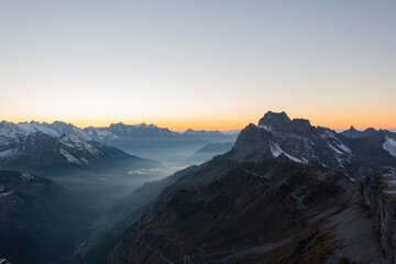 Fototapeta na wymiar Amazing shot of a beautiful landscape in the alps of Switzerland. Wonderful flight with a drone over an amazing landscape in the canton of Glarus. Epic view at sunset.