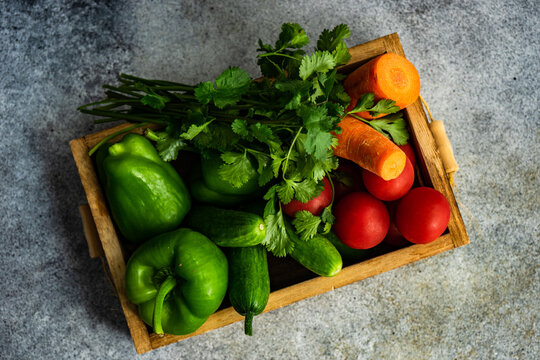Overhead view of a box of fresh vegetables and coriander