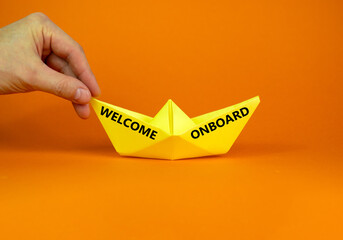 Welcome onboard and support symbol. Concept words Welcome onboard on yellow paper boat on a...