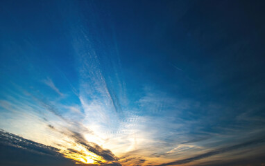 blue sky with spindrift clouds at sunset