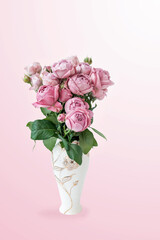 bouquet of pink flowers in a white vase is highlighted on a pink gradient background for congratulations on Mother's Day, Valentine's Day or an invitation to a wedding.
