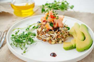 Sprouts of whole wheat, whole oats, peas and sunflower with a piece of salmon and avocado. Organic grains are good for salads and bread. concept of raw healthy food