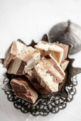 plate with halva made of sunflower seeds on a bronze tray, selective focus. Still life with halva in Arabic style