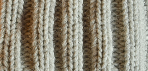 Fototapeta premium large knitting needles. texture with gray woolen threads. background for the design. the pattern is in braids.