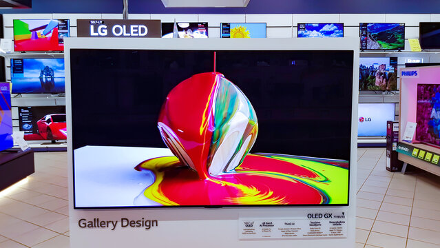 Latvia, Riga, February, 2022 - Showroom of modern electronics with new generation large TV-sets with technology QLED in the shopping mall in Riga, Latvia