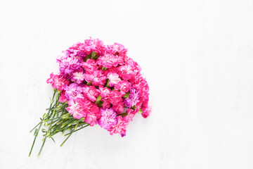 Pink carnation flowers bouquet on a light background. Mothers Day, Valentines Day, birthday concept