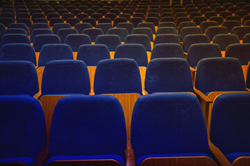 auditorium without people with blue chairs