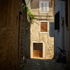 Fototapeta na wymiar historical for the region typical house in an alley in the old town of Krk in Croatia