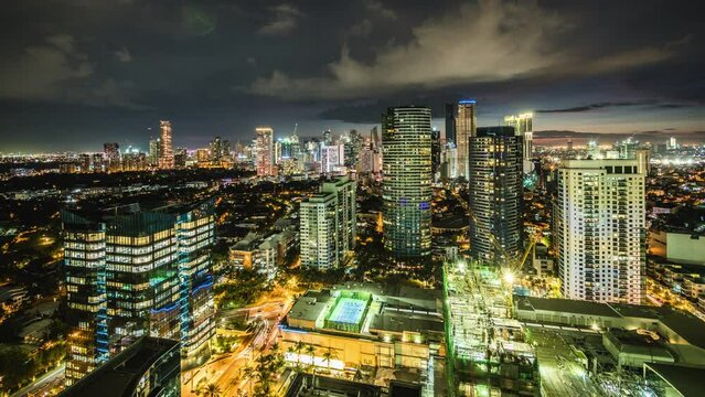 Dusk to night time lapse view looking over modern buildings in Makati City, Metro Manila, Philippines. 