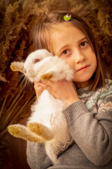 Fototapeta na wymiar Young beautiful girl with little rabbit. Easter portrait. Close up. Vertical image.