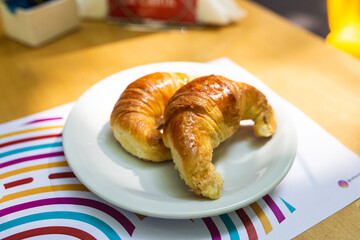croissant on plate on wooden table