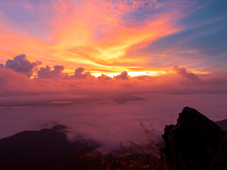 morning sea mist with romantic golden sun rise on cloudy fog twilight sky at Pha Tang hill in...