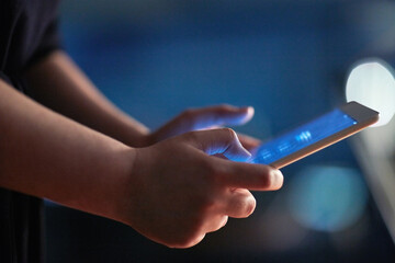 Late night on the net. Cropped shot of a woman using a digital tablet at night.