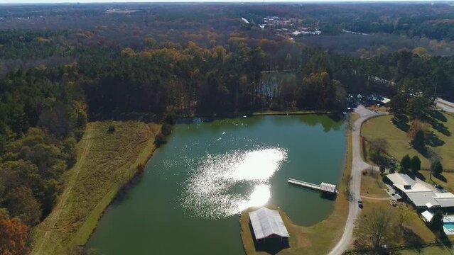 Aerial drone view circle green lake with sun shadow left to right