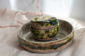 
set of brown and green handmade clay plates
