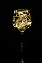 Fairy Light in a wine glass, in the Dark, Low-Key Photography.