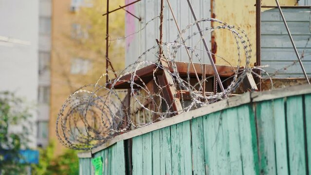 Barbed wire. Prison fence. View at the barb wall of the crime area or closed military camp. Security, Protection and Exclusion.