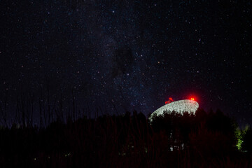 Radio telescope antenna against the background of the night starry sky