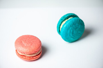 Colorful macarons cake, top view flat lay, fly falling sweet macaroon on color white isolated background. Minimal concepts falling macaroons pattern above, food natural background