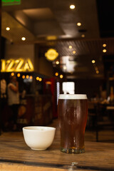 craft beer next to salted peanuts