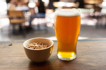 craft beer next to salted peanuts