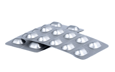 Two blister packs of pills isolated on a white background.