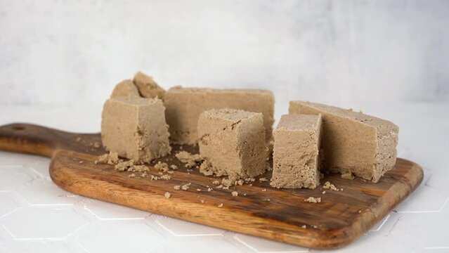 Traditional eastern dessert halva or sesame on a wooden cutting board. Zoom-in.